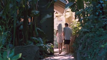 Movie still from “Somewhere” (2010), directed by Sofia Coppola – A man and a woman walking down a path; Wide shot, High angle