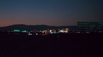 Movie still from “Somewhere” (2010), directed by Sofia Coppola – A view of a city skyline at night from a field; Extreme Wide shot, Low angle