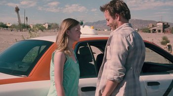 Movie still from “Somewhere” (2010), directed by Sofia Coppola – A man and a woman standing in front of a car; Medium shot, Over the shoulder angle