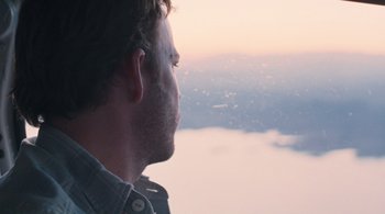 Movie still from “Somewhere” (2010), directed by Sofia Coppola – A person looking out a window; Close Up shot, High angle