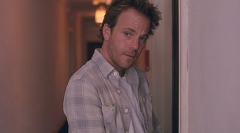Movie still from “Somewhere” (2010), directed by Sofia Coppola – A person wearing a plaid shirt; Close Up shot, Low angle