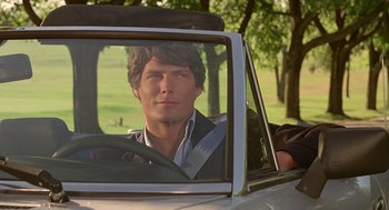 Movie still from “Somewhere in Time” (1980), directed by Jeannot Szwarc – A man sitting in the driver's seat of a car; Close Up shot, Over the shoulder angle