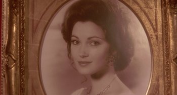 Movie still from “Somewhere in Time” (1980), directed by Jeannot Szwarc – An old photo of a woman in a white dress; Extreme Close Up shot, High angle