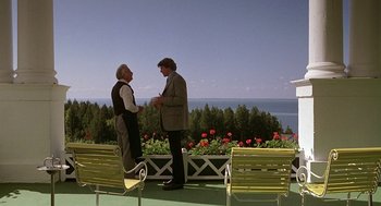 Movie still from “Somewhere in Time” (1980), directed by Jeannot Szwarc – Two men standing next to each other on a bench; Wide shot, High angle