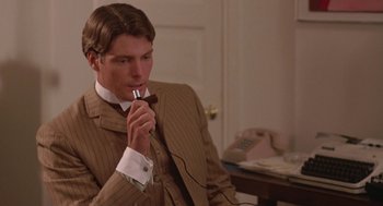 Movie still from “Somewhere in Time” (1980), directed by Jeannot Szwarc – A man in a suit and tie holding an electronic device; Close Up shot, Over the shoulder angle