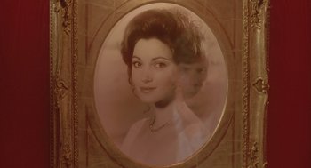 Movie still from “Somewhere in Time” (1980), directed by Jeannot Szwarc – An old photo of a woman in a dress and necklace; Close Up shot, Over the shoulder angle
