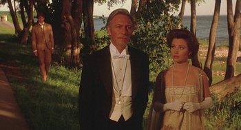 Movie still from “Somewhere in Time” (1980), directed by Jeannot Szwarc – A man and a woman dressed in formal attire; Medium shot, Over the shoulder angle