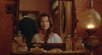 Movie still from “Somewhere in Time” (1980), directed by Jeannot Szwarc – A woman sitting in front of a bathroom mirror; Close Up shot, Over the shoulder angle