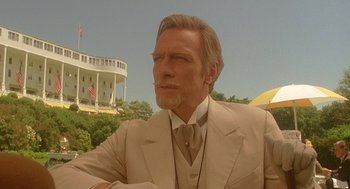Movie still from “Somewhere in Time” (1980), directed by Jeannot Szwarc – A person wearing a suit and tie; Close Up shot, Low angle