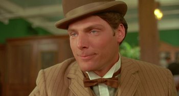 Movie still from “Somewhere in Time” (1980), directed by Jeannot Szwarc – A person wearing a suit and a hat; Close Up shot, Over the shoulder angle