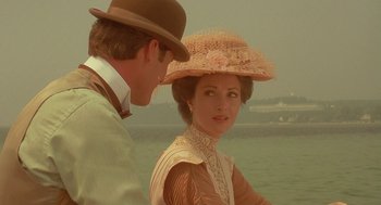 Movie still from “Somewhere in Time” (1980), directed by Jeannot Szwarc – A man and a woman standing next to a body of water; Close Up shot, Over the shoulder angle
