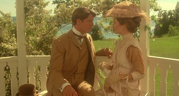 Movie still from “Somewhere in Time” (1980), directed by Jeannot Szwarc – A man and a woman sitting next to each other on a park bench; Medium shot, Over the shoulder angle