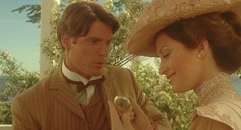 Movie still from “Somewhere in Time” (1980), directed by Jeannot Szwarc – A man and a woman wearing suits and a hat; Close Up shot, Over the shoulder angle