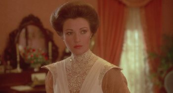 Movie still from “Somewhere in Time” (1980), directed by Jeannot Szwarc – A person wearing a white dress; Close Up shot, Over the shoulder angle