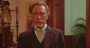 Movie still from “Somewhere in Time” (1980), directed by Jeannot Szwarc – A person wearing a suit and tie; Close Up shot, Low angle