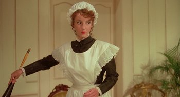 Movie still from “Somewhere in Time” (1980), directed by Jeannot Szwarc – A woman dressed as a maid posing for a picture; Medium shot, Low angle