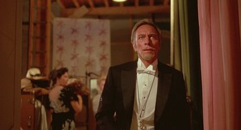 Movie still from “Somewhere in Time” (1980), directed by Jeannot Szwarc – A man in a tuxedo standing next to a woman; Close Up shot, Low angle