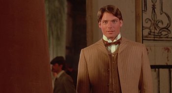 Movie still from “Somewhere in Time” (1980), directed by Jeannot Szwarc – A man in a suit and tie standing in front of a mirror; Close Up shot, Over the shoulder angle