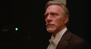 Movie still from “Somewhere in Time” (1980), directed by Jeannot Szwarc – A person wearing a suit and tie; Close Up shot, Low angle