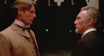 Movie still from “Somewhere in Time” (1980), directed by Jeannot Szwarc – A man and a woman standing next to each other in front of lights; Close Up shot, Over the shoulder angle