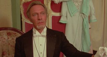 Movie still from “Somewhere in Time” (1980), directed by Jeannot Szwarc – A man in a tuxedo standing in front of mannequins; Close Up shot, Low angle