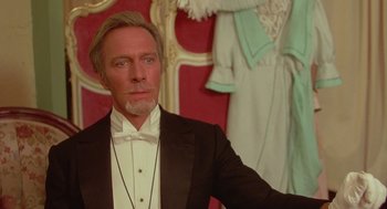 Movie still from “Somewhere in Time” (1980), directed by Jeannot Szwarc – A man in a tuxedo standing in front of mannequins; Close Up shot, Low angle