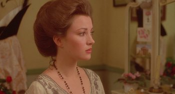 Movie still from “Somewhere in Time” (1980), directed by Jeannot Szwarc – A beautiful woman with long brown hair wearing a necklace; Close Up shot, Over the shoulder angle