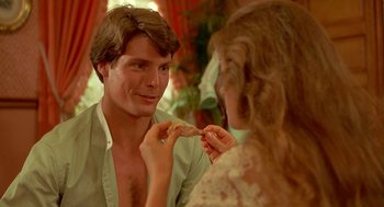 Movie still from “Somewhere in Time” (1980), directed by Jeannot Szwarc – A man and a woman looking in the same direction in the mirror; Close Up shot, Over the shoulder angle