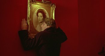 Movie still from “Somewhere in Time” (1980), directed by Jeannot Szwarc – A man holding onto a picture of a woman; Close Up shot, Over the shoulder angle
