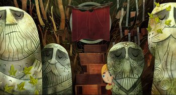 Movie still from “Song of the Sea” (2014), directed by Tomm Moore – A girl standing in front of two large statues; Wide shot, Overhead angle