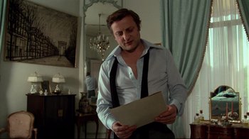 Movie still from “Sorcerer” (1977), directed by William Friedkin – A man holding a piece of paper in his hands; Medium shot, Low angle