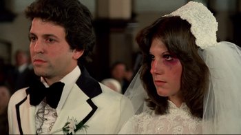 Movie still from “Sorcerer” (1977), directed by William Friedkin – A man and a woman in wedding attire; Close Up shot, High angle