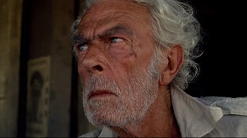 Movie still from “Sorcerer” (1977), directed by William Friedkin – An old man with white hair and blue eyes; Close Up shot, Low angle