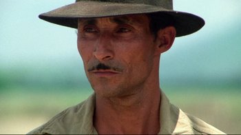 Movie still from “Sorcerer” (1977), directed by William Friedkin – A person wearing a hat; Close Up shot, Low angle