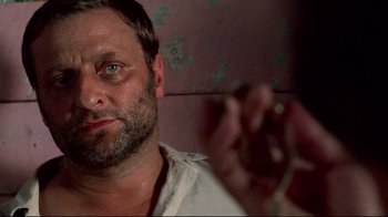 Movie still from “Sorcerer” (1977), directed by William Friedkin – A person holding something in his hand; Close Up shot, High angle