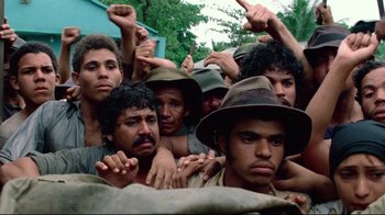 Movie still from “Sorcerer” (1977), directed by William Friedkin – A group of men standing next to each other; Close Up shot, High angle