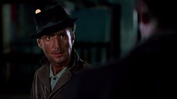 Movie still from “Sorcerer” (1977), directed by William Friedkin – A person wearing a hat; Close Up shot, Over the shoulder angle
