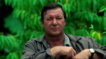 Movie still from “Sorcerer” (1977), directed by William Friedkin – A person wearing a shirt; Close Up shot, Low angle