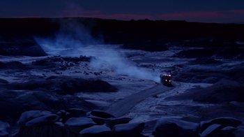 Movie still from “Sorcerer” (1977), directed by William Friedkin – A truck driving down a snowy road at night; Extreme Wide shot, High angle