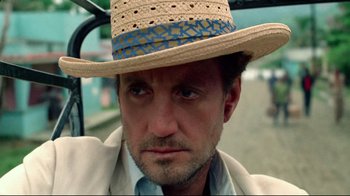 Movie still from “Sorcerer” (1977), directed by William Friedkin – A person wearing a straw hat; Close Up shot, Low angle