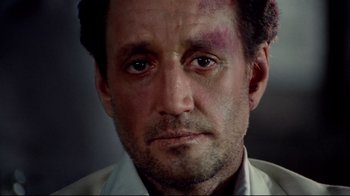 Movie still from “Sorcerer” (1977), directed by William Friedkin – A person with bruises on his face; Close Up shot, Low angle