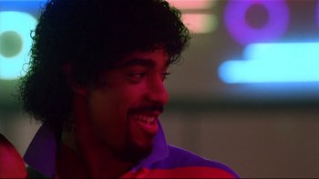 Movie still from “Soul Food” (1997), directed by George Tillman Jr. – A person with curly hair smiling; Close Up shot, Low angle