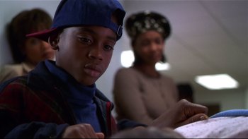 Movie still from “Soul Food” (1997), directed by George Tillman Jr. – A young man and a woman sitting at a table; Close Up shot, Over the shoulder angle