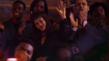 Movie still from “Soul Food” (1997), directed by George Tillman Jr. – A group of people sitting in a room waving; Medium shot, High angle