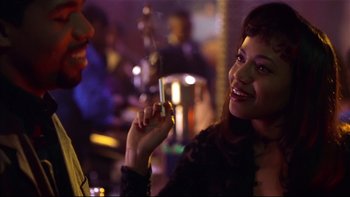 Movie still from “Soul Food” (1997), directed by George Tillman Jr. – A woman is holding a glass of wine in her hand; Close Up shot, Over the shoulder angle