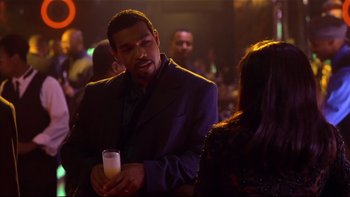 Movie still from “Soul Food” (1997), directed by George Tillman Jr. – A man in a suit and tie holding a glass of milk; Medium shot, Over the shoulder angle