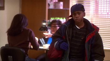 Movie still from “Soul Food” (1997), directed by George Tillman Jr. – A young boy with a hat and a backpack; Medium shot, Over the shoulder angle