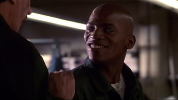Movie still from “Soul Food” (1997), directed by George Tillman Jr. – A man smiling and holding his fist up in the air; Close Up shot, Low angle