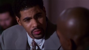 Movie still from “Soul Food” (1997), directed by George Tillman Jr. – A person wearing a suit and tie; Close Up shot, High angle