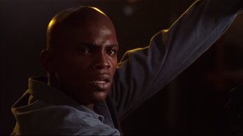 Movie still from “Soul Food” (1997), directed by George Tillman Jr. – A man with his hand raised up in the air; Close Up shot, Low angle